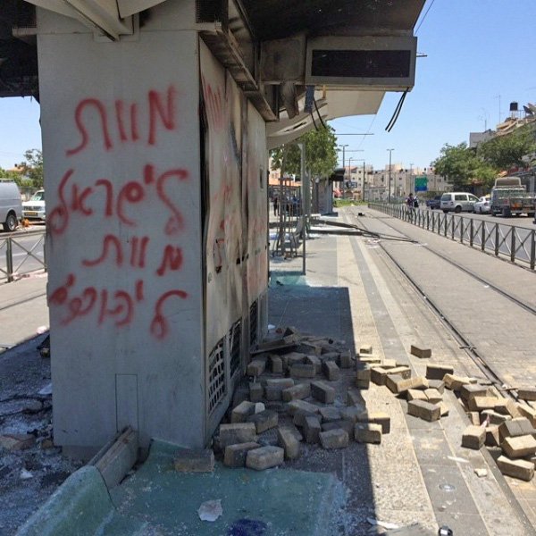 Vandalized tram station in Shuafat neighborhood, Jerusalem. Graffiti -- in Hebrew -- reads "death to Israel, death to Jews"