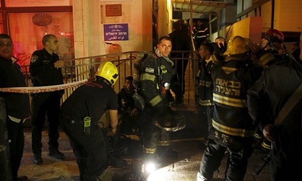 Israeli firefighters extinguish fire at the Jerusalem offices of B'Tselem